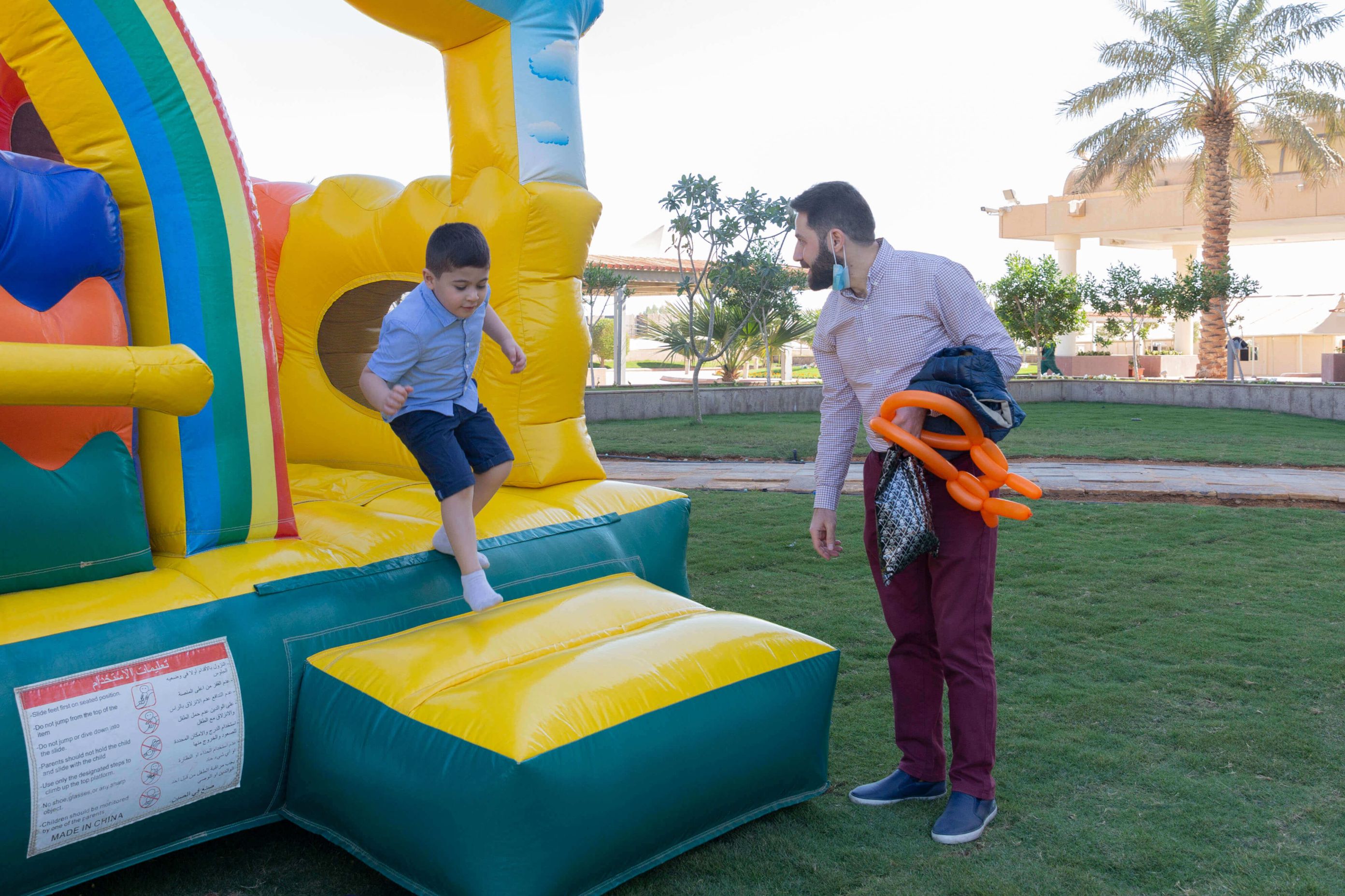 أب يلعب مع أبنائه في اليوم العالمي للطفل