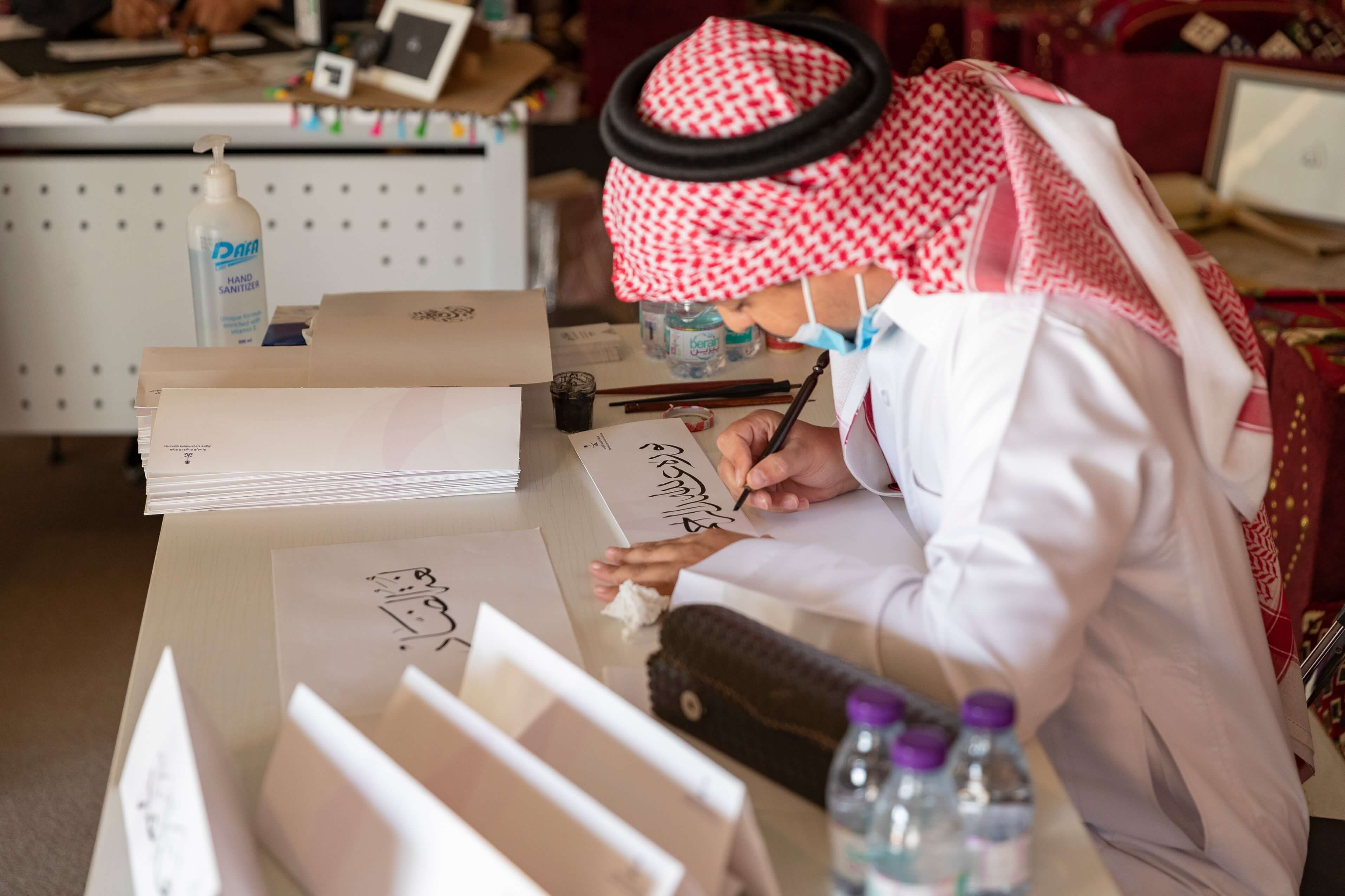 A calligrapher writes on Arabic language day