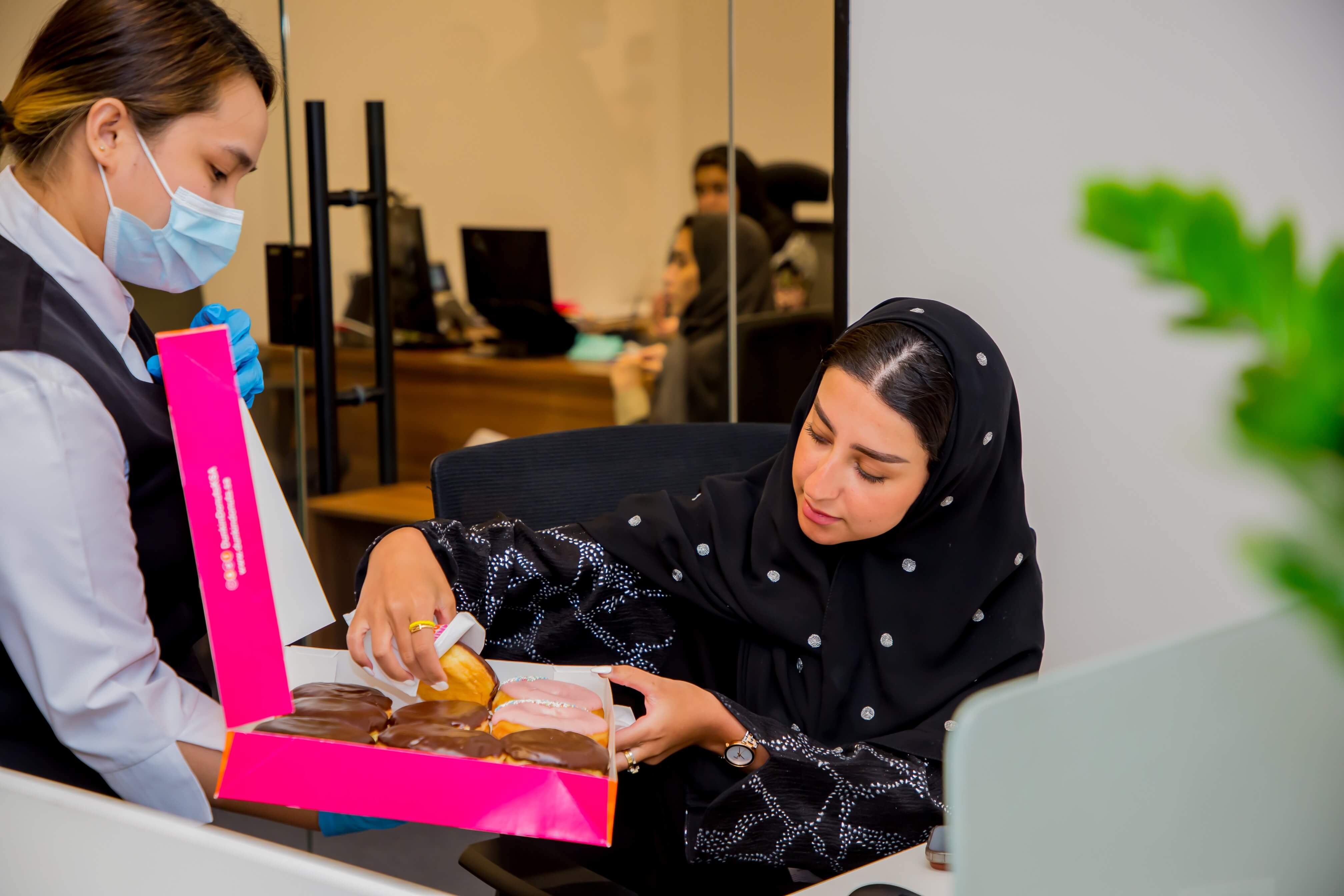 An employee of the authority eating Eid al-Adha sweets 2022
